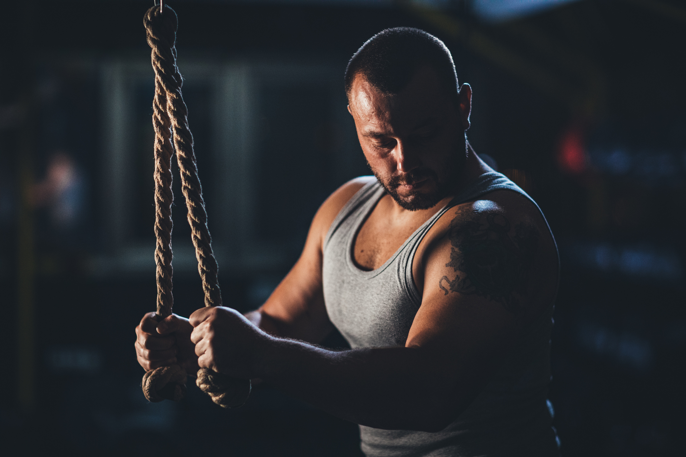 Man body builder training in dark gym